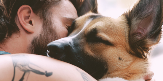 Man cuddling with his dog.