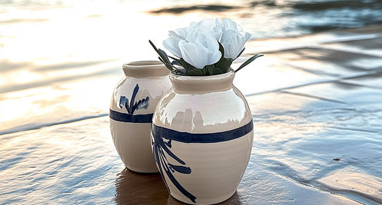 Two small dog urns on the beach
